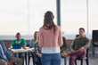 © Laflor2000/peopleimages.com - Lecturer, woman and lesson with students at college for exam preparation, learning support or advice. Tutor, back of person and discussion with people in lecture for test feedback and study guidance
