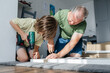 © Elena Medoks - Father and son assembling furniture at home for improvement