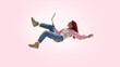 © Lustre Art Group  - Young freelancer working remotely with laptop in mid air. Concept of location independent work, creative freedom, digital services, modern self employed career path.