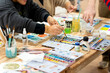© Alfonso Soler - Adults learning watercolor painting during art class