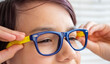 © kittyfly - teenage boy wearing blue eyeglasses, touching frames, clear vision, eyesight correction, medical optics, Focus and clarity, childhood health, first glasses experience, Childhood and education