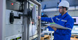 © reewungjunerr - Electrical engineer male checking voltage at the Power Distribution Cabinet in the control room,preventive maintenance Yearly,inspecting power system and control panel in industrial factory