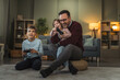 © Miljan Živković - Father playing video games with son and daughter