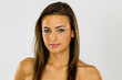 © Grindstone Media - Elegance in Focus: Studio Portrait of a Confident Brunette Fashion Model