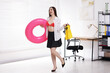 © New Africa - Woman with inflatable ring and swimfins in office