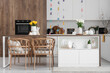 © Pixel-Shot - Interior of light kitchen decorated for Easter with table and tulips in vases