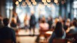 © Rostyslav - Blurry background of people attending indoor conference with warm bokeh lighting