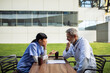 © Marko Geber - Healthcare professionals discussing case outdoors at hospital