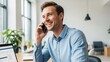 © shornagraphiclab - Smiling businessman talking on phone in modern office