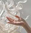 © Qazy - Female hand with water drops surrounded by swirling translucent ribbons