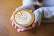 © Farknot Architect - Closeup image of a woman holding a cup of hot latte coffee