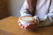 © Farknot Architect - Closeup image of a woman holding a cup of hot latte coffee