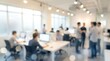 © CuteBee - A blurred image of a bright, modern open office shows employees working at desks and standing, creating a lively and collaborative workplace.