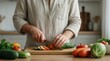 © Roman - Someone is cutting up vegetables on a cutting board in the kitchen
