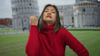 © Krakenimages.com - Woman gesturing near pisa tower with expressive emotions in outdoor italian city setting.