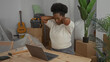 © Krakenimages.com - Young woman stretches at desk in new apartment surrounded by boxes and plants showing everyday life and transition in cozy living room.