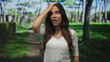© Krakenimages.com - Young hispanic woman with hand on forehead in forest park path, mouth open and visibly wide eyed; surprise.