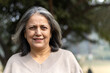 © Pix4Ads - Close shot of a happy indian elder woman fun at park. Portrait of a cute, attractive, blonde, lovely, elegant and beautiful senior woman spending leisure time at outdoors background nature, copy space