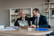 © Vladimir Borovic - Father and Son Businessmen Working Together in Modern Office Senior and Middle Aged Businessmen