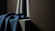 © PNGLovers - Moody, textured dark navy blue fabric draped elegantly over a rough concrete block, contrasted against a vertically paneled dark wood background under dramatic side lighting, evoking a sense of