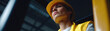 © Nattapol - Female construction worker hard hat safety vest confidence low angle portrait industry professional serious expression workplace safety