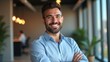 © rahwik - business man smiling confidently in modern office portrait happy employee at creative media agency in qatar expressing pride excitement and career growth professional startup workplace