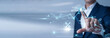 © Theyone - International executive pointing at data network and Global Business on digital interface. Worldwide corporate networking, international trade, and cross-border enterprise collaboration.
