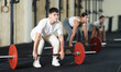 © JackF - Young guy in sportswear lifting heavy barbell in gym