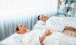© InfiniteFlow - Caucasian couple customer enjoying relaxing anti-stress spa massage and pampering with beauty skin recreation leisure in day light ambient salon spa at luxury resort or hotel. Quiescent