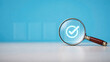 © Gambar Upi - Magnifying glass inspecting digital verification checkmark icons representing document validation data review quality control and compliance technology concept