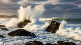 Powerful ocean waves crashing against rocks at sunset