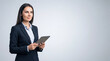 © Five Million Stock - 40s mature professional business leader executive woman office worker holding tablet computer isolated. Latin hispanic middle aged businesswoman thinking, dreaming looking away. Web banner, copy space
