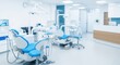 © Dara - Modern dental office with blue and white dental chairs and equipment.
