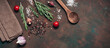© Yulia - Dark culinary background with cooking ingredients, spices, herbs, a wooden spoon, and a linen napkin. Top view, flat lay, copy space. Banner
