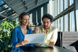 © Westend61 - Smiling business people having discussion over tablet PC