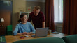 © Татьяна Епанешникова - Boss man checks asian woman subordinate do task correctly report. Management satisfied work. Employee right answer. Good job. Guy show laptop screen. Multi racial national couple online shopping home.
