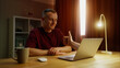 © Татьяна Епанешникова - Business man see thump up remotely, thumbup like ok from laptop screen. Approval at home. Male employee virtual meeting. Successful distant interview. Guy good job video call. Work deal conference.