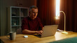 © Татьяна Епанешникова - Man remote worker get ready work home. Guy come early morning sit down desk open laptop type keyboard. Male employee surfing net. Busy serious person use pc. Online computer freelancer. Distant job.