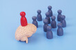© Valerii Evlakhov - Red people figure on human brain and crowd of grey figures on blue background. Concept of knowledge, leadership and education.