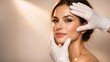 © Loginova - Close up beauty portrait during cosmetic facial examination, gloved hands framing face in clinic, skincare and aesthetics concept.
