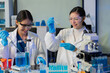 © NINENII - Scientists conducting research in a biotechnology lab, using pipettes and test tubes for medical and chemical experiments. Innovation in chemistry, healthcare, and medicine.