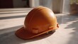 © Thares2020 - An orange construction hard hat rests on a marble floor illuminated by sunlight casting distinct shadows