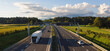 © 24K-Production - Trucks travel on a highway surrounded by fields, driving goods for e-commerce and supporting logistics networks.