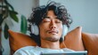 © Yevheniiya - An asian man enjoying his music and some peace while wearing white headphones.