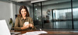 © insta_photos - Smiling mature business woman executive using mobile phone working in office. Happy middle aged businesswoman holding smartphone, professional female executive looking at cellphone at workplace.