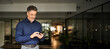 © insta_photos - Smiling mature business man corporate leader using cellphone standing in office. Happy busy middle aged older male entrepreneur holding mobile phone tech device looking at smartphone at work.