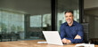 © insta_photos - Portrait of happy mature professional business owner man manager, smiling senior male ceo executive, middle aged corporate leader working on laptop computer looking at camera sitting in office.