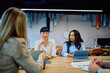 © we.bond.creations - Professional women having a business meeting in a modern office, working together on projects and discussing new ideas
