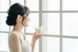 © buritora - Asian woman drinking milk in the morning at home