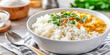 © Rachakrit - Rice bowl with creamy curry and fresh herbs served on cloth with spoon, warm and comforting meal